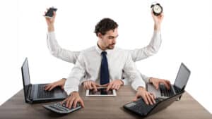 Businessman stressed by too many tasks in the office
