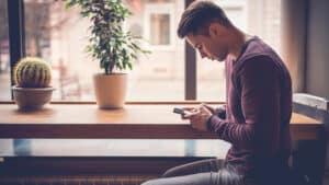 Lonely man holding a phone