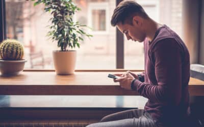 Lonely man holding a phone