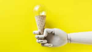 Robot hand holding a light bulb ice cream