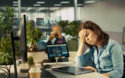 A tired woman employee sitting in front on her closed laptop