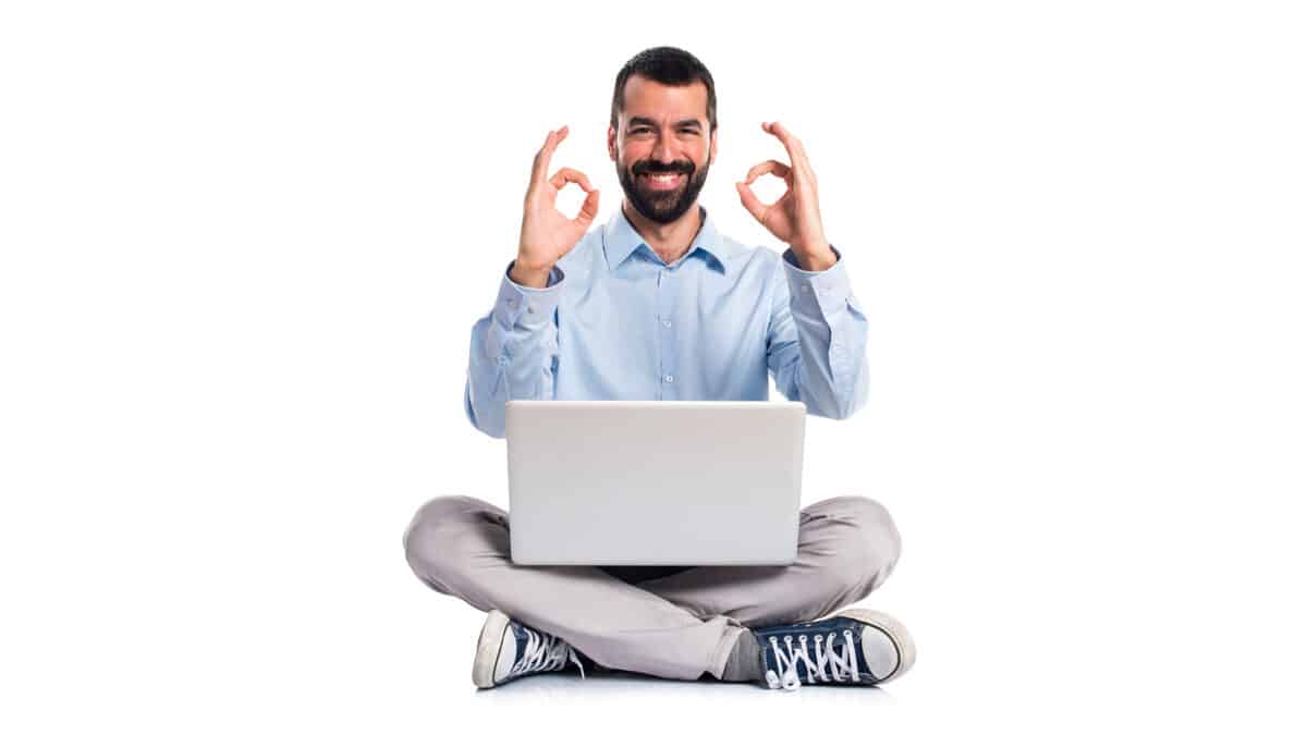 Man with laptop making OK sign