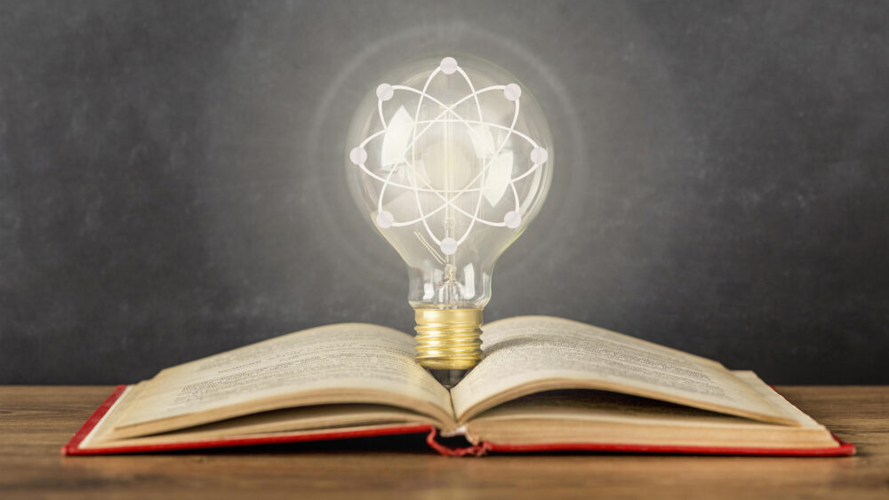 Book and a light bulb. Close-up idea concept