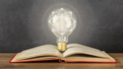 Book and a light bulb. Close-up idea concept