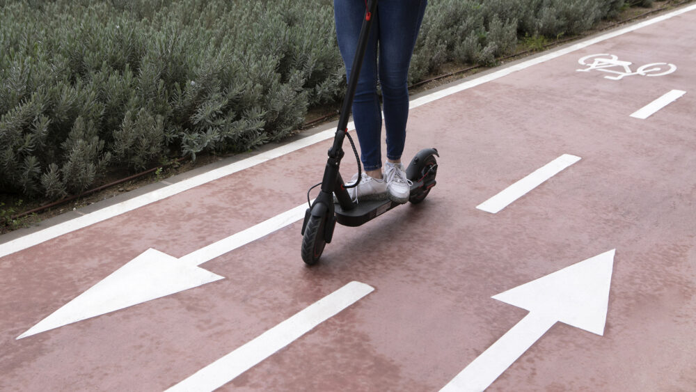 Young adult using electric scooter for transportation